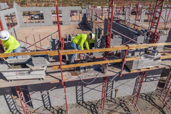 These Masons are laying many bricks and also cutting them at the same time. Hirschi Masonry of Las Vegas, Nevada